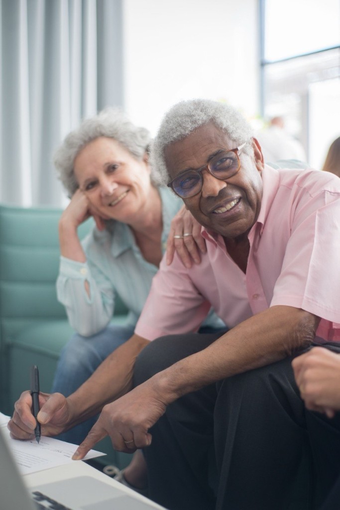 Couple reviewing documents while planning their investment strategy
